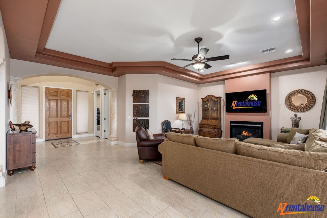 Relax in your spacious living room with cozy seating, elegant fireplace, and entertainment center for perfect evenings together.