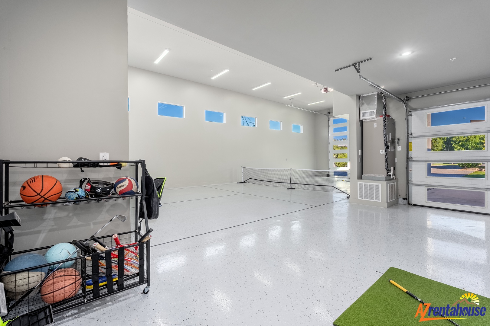 Your private garage transforms into the ultimate game room with a tennis court setup and sports equipment storage.