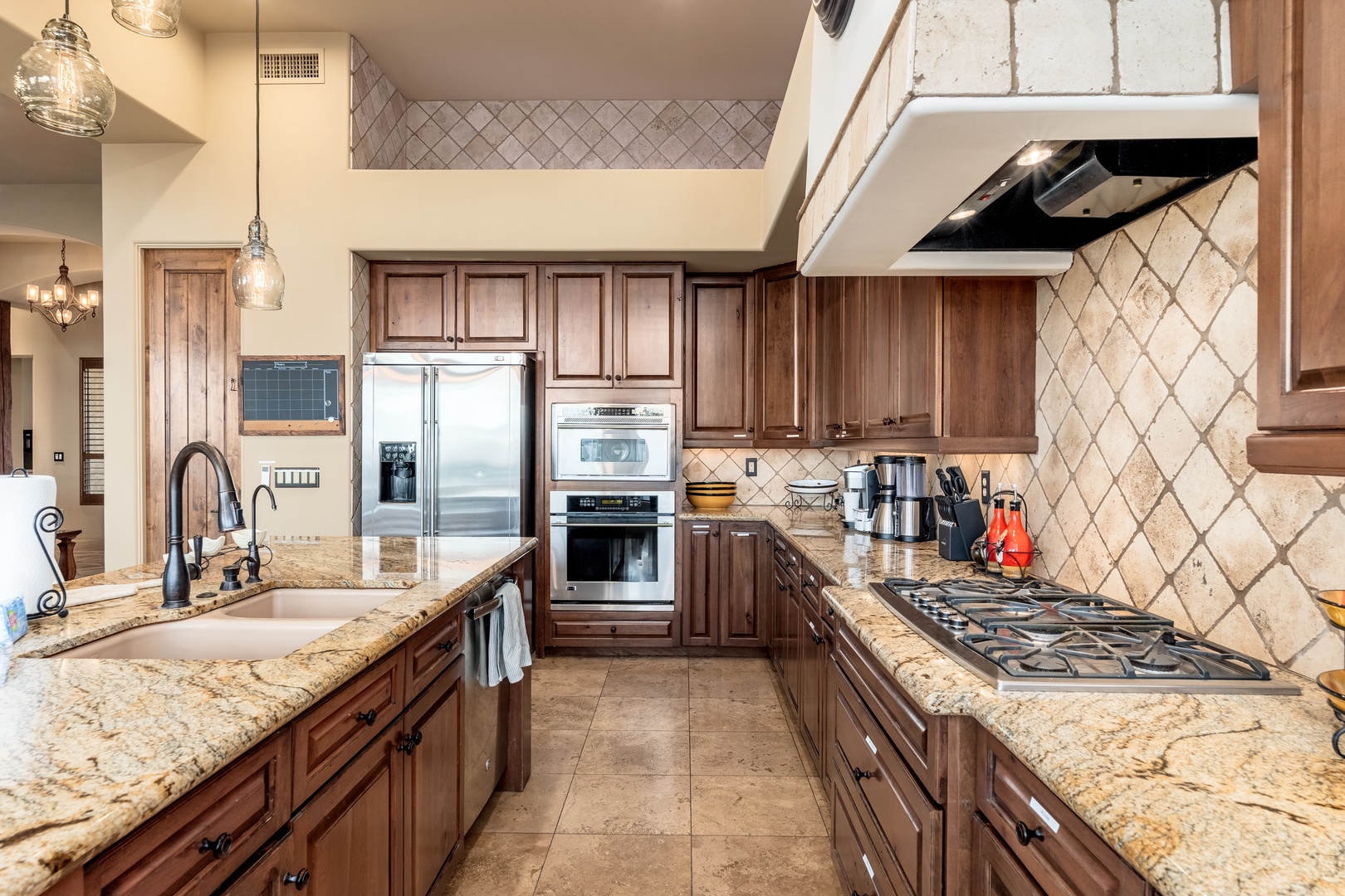 Picture yourself preparing meals in this spacious chef's kitchen, where gleaming granite counters, rich wood cabinetry, and modern appliances await your culinary adventures.