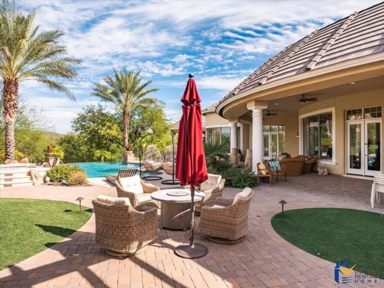Luxurious backyard oasis with sparkling pool, comfortable seating, and putting green - your perfect desert retreat.