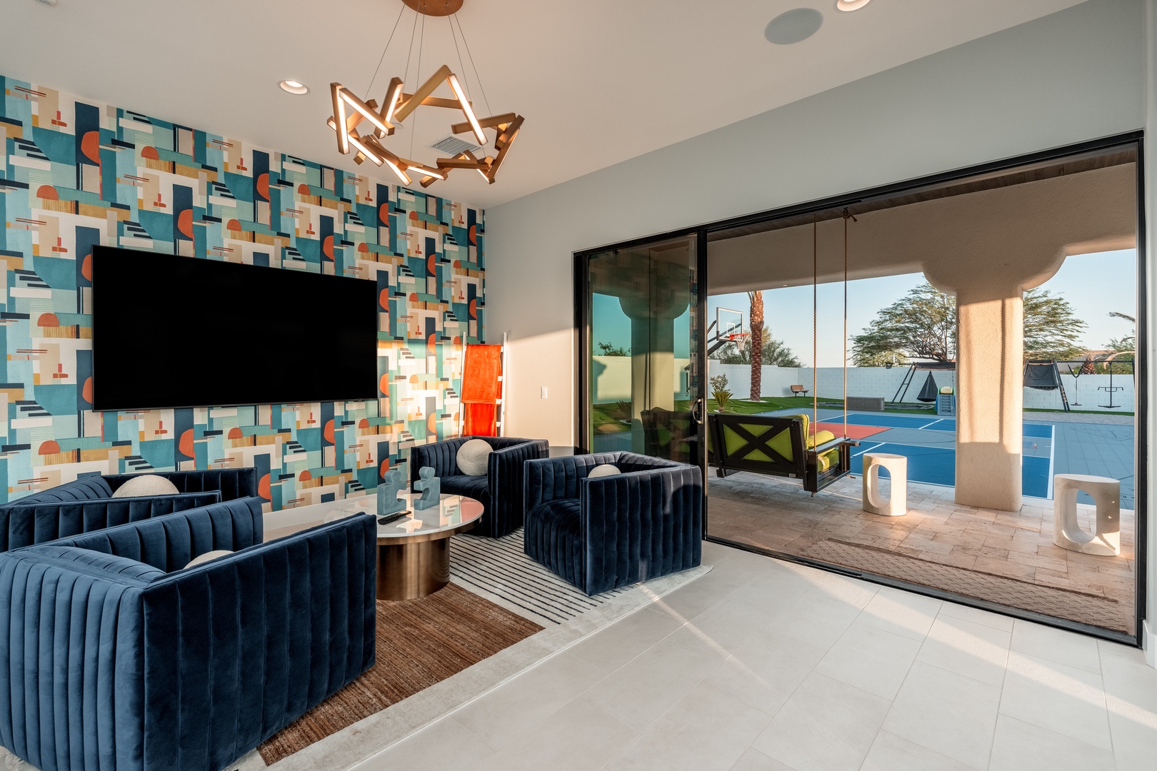 Unwind in your modern living room with plush seating, bold design accents, and seamless access to your private patio and pool—your personal retreat awaits.