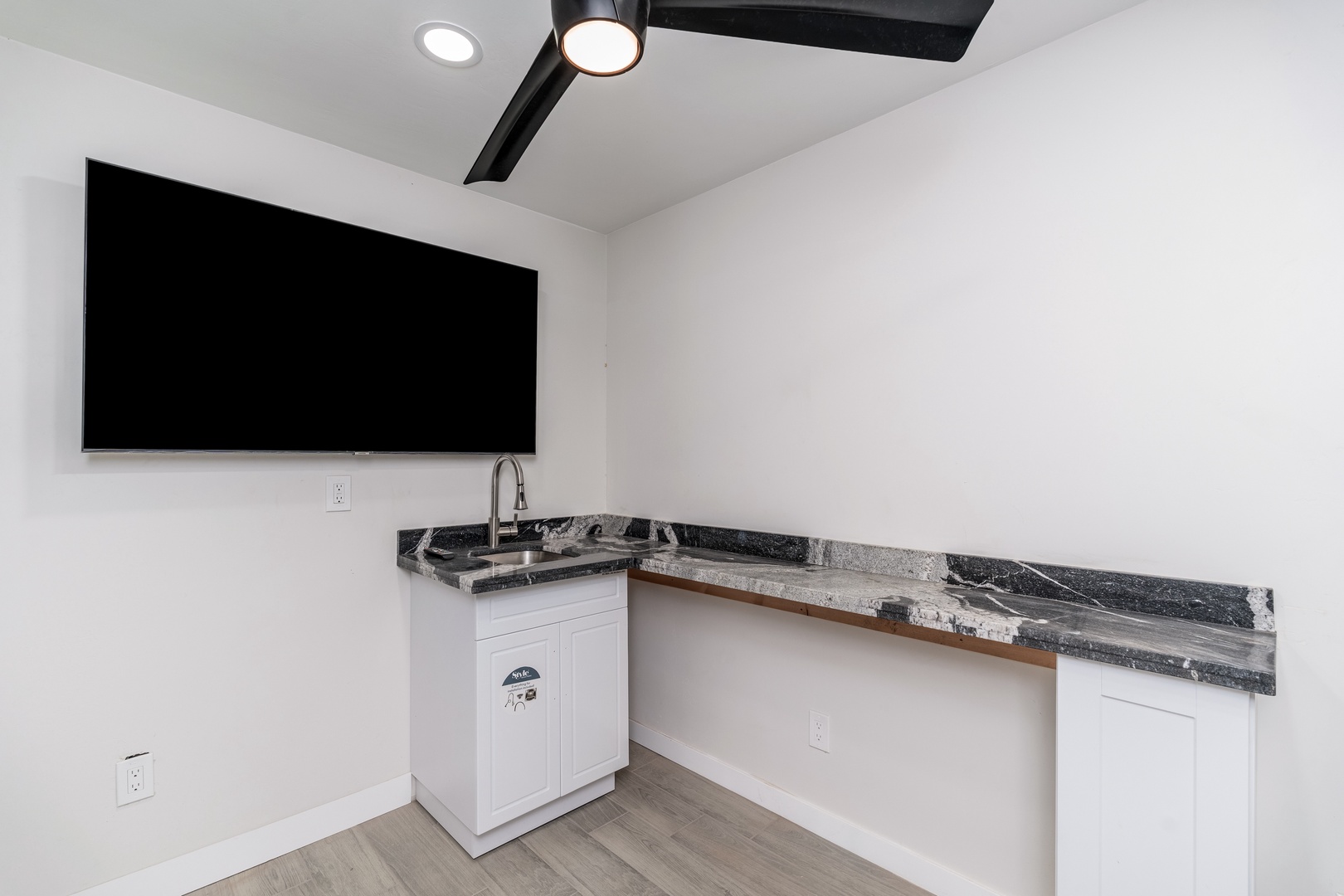 Your sleek kitchenette features stunning granite countertops and modern fixtures, perfect for quick meals or morning coffee while catching up on your favorite shows.