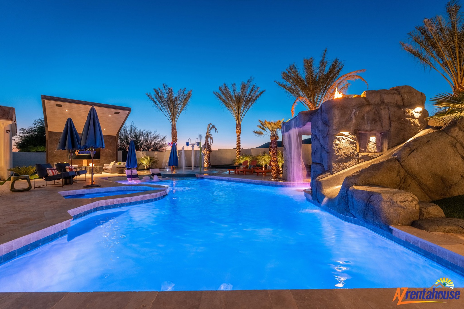 Dive into your private oasis with waterfall features and poolside luxury under the desert sky.