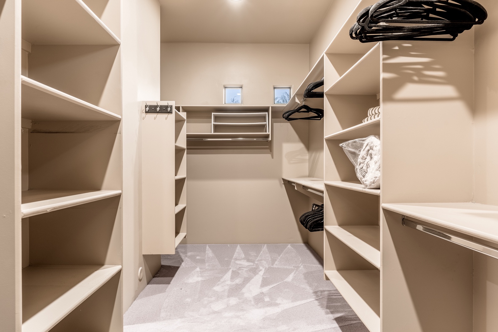 Your spacious walk-in closet features custom shelving and hanging space, giving you plenty of room to unpack and settle in comfortably during your stay.