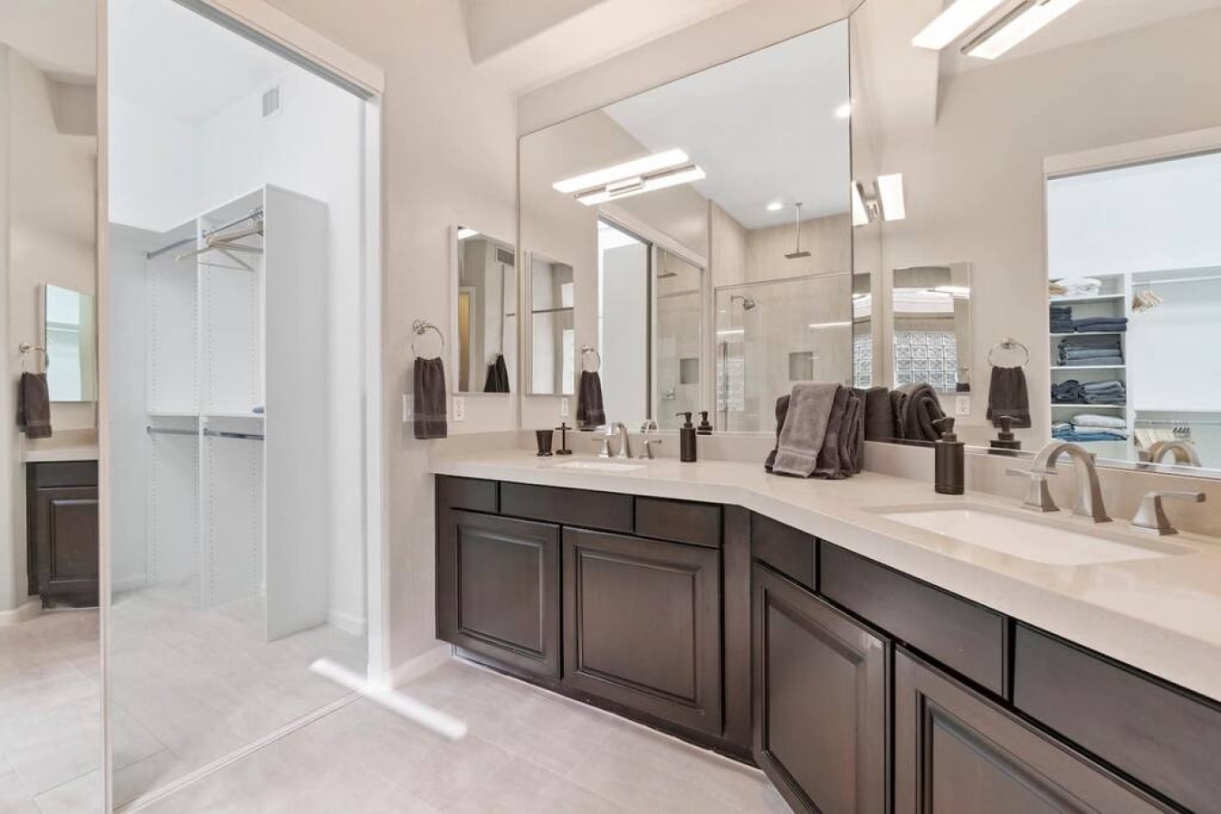 Step into your luxurious ensuite featuring dual vanities, marble countertops, and a spacious walk-in shower for your morning routine.