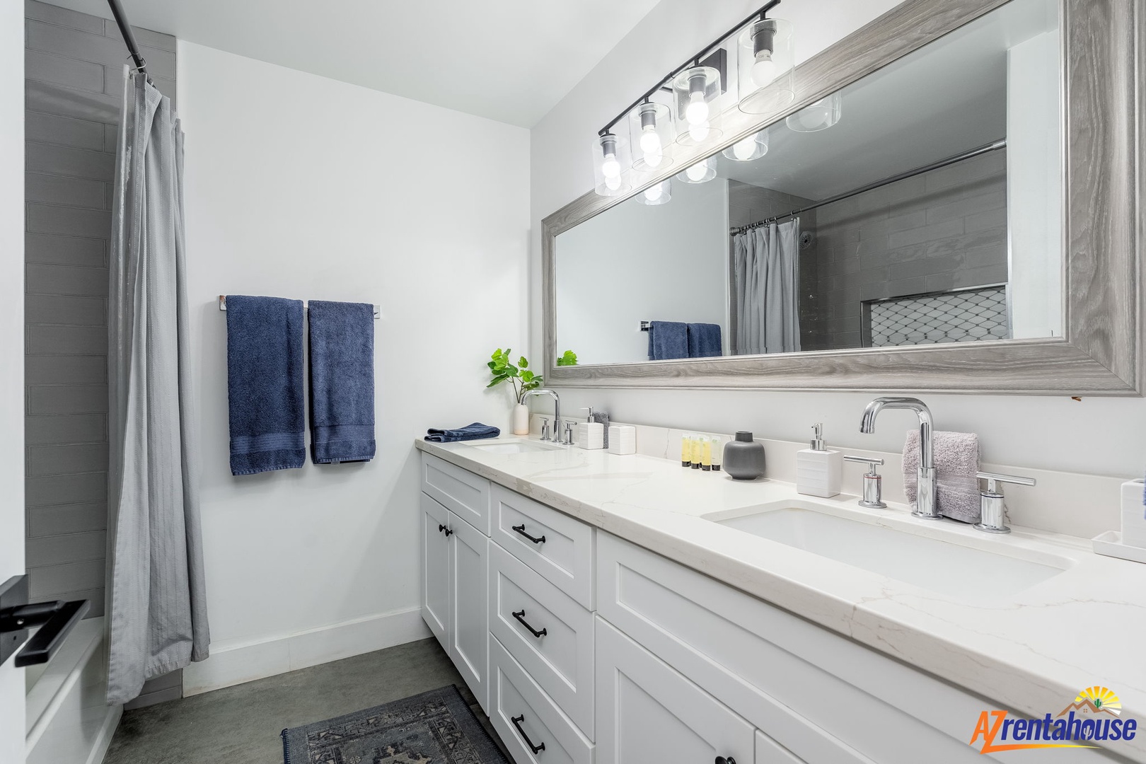 Refresh in your spacious bathroom with dual sinks, pristine counters, and thoughtful touches like fresh towels waiting for you.