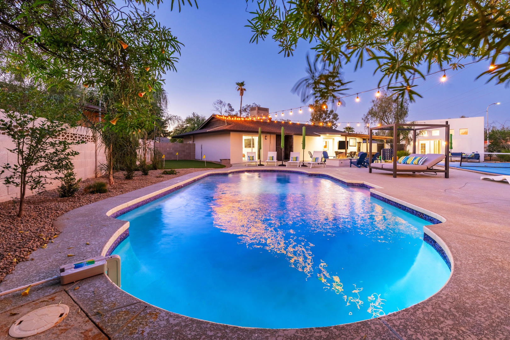 Dive into your own private oasis, where the sparkling pool glows under string lights and the desert evening wraps you in warmth and tranquility.