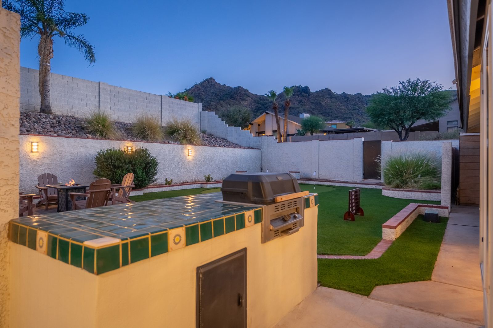 Step onto your private patio where the Arizona mountains create a stunning backdrop. Fire up the built-in grill as the evening lights illuminate your lush lawn and cozy outdoor seating area.