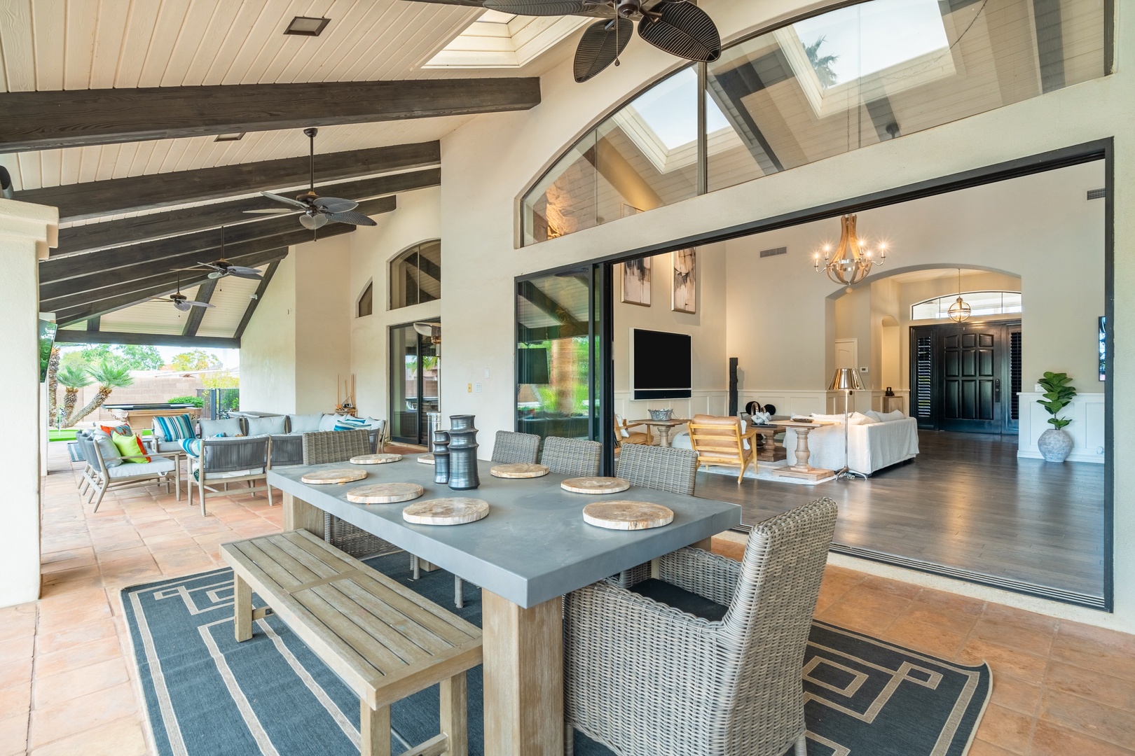 Open-concept living flows seamlessly to your covered patio, where soaring ceilings and tropical breezes create an airy, inviting space for dining and relaxation.