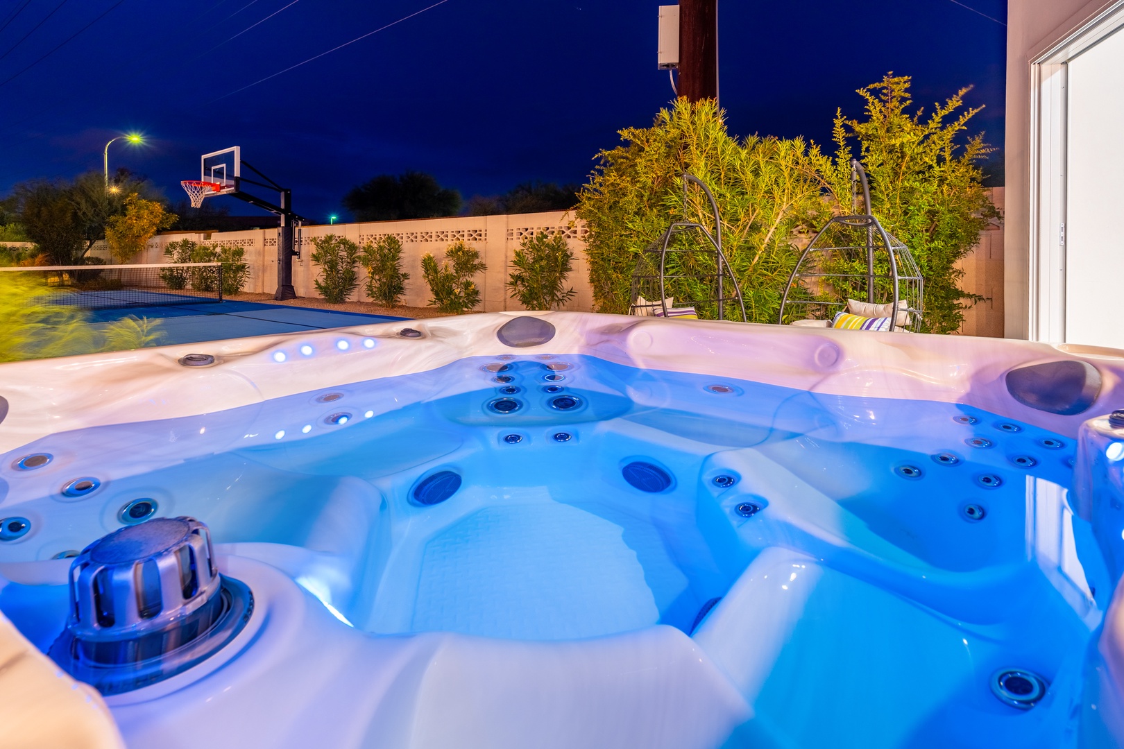 Slip into your private hot tub under the stars—the glowing jets and warm water invite you to unwind after a perfect day exploring.