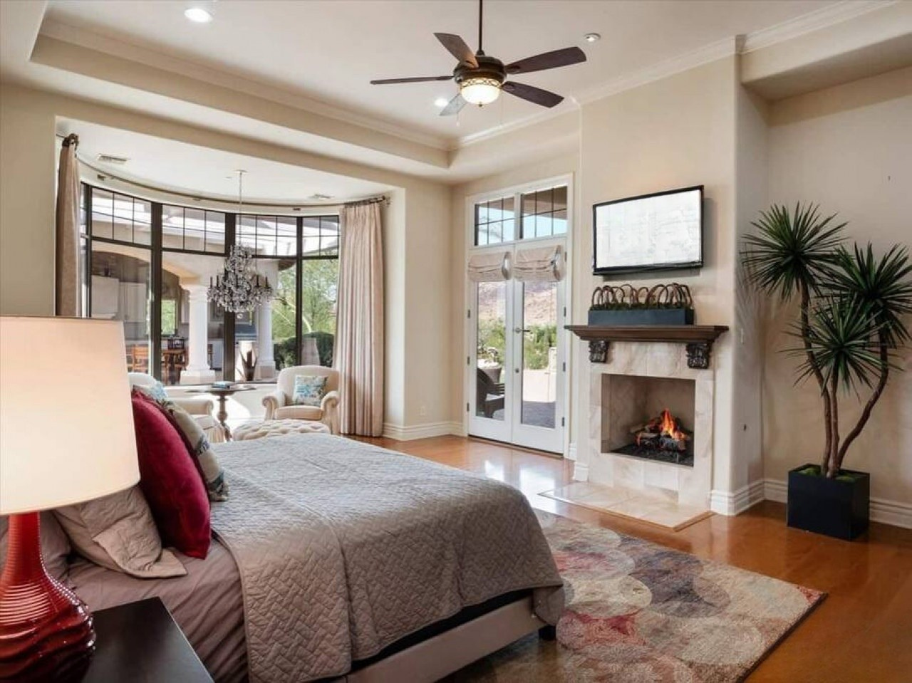 Unwind in your elegant suite where hardwood floors meet plush comfort. A crackling fireplace and French doors opening to the courtyard create your perfect retreat.
