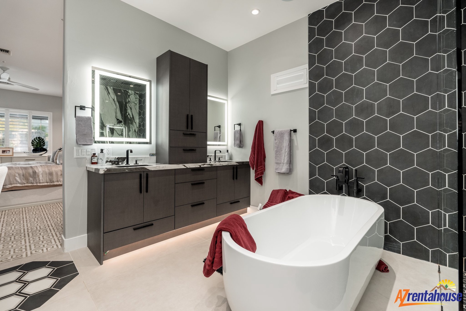 Unwind in your luxurious spa-style bathroom with a stunning soaking tub, modern dual vanities, and elegant hexagonal tile that creates the perfect retreat.