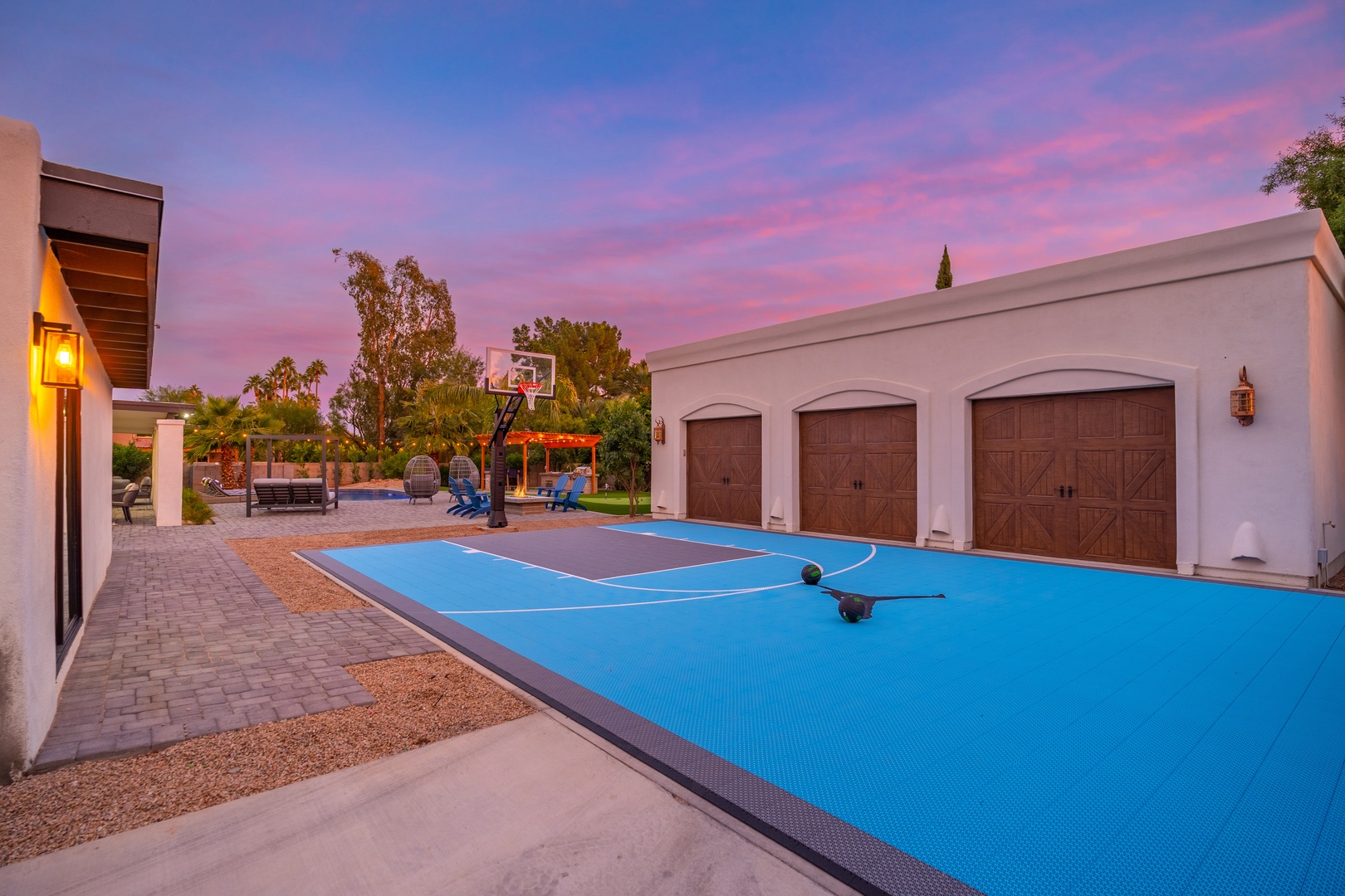 A private outdoor basketball court awaits beneath vibrant twilight skies, offering your group a dedicated space for friendly games and active fun during your stay.