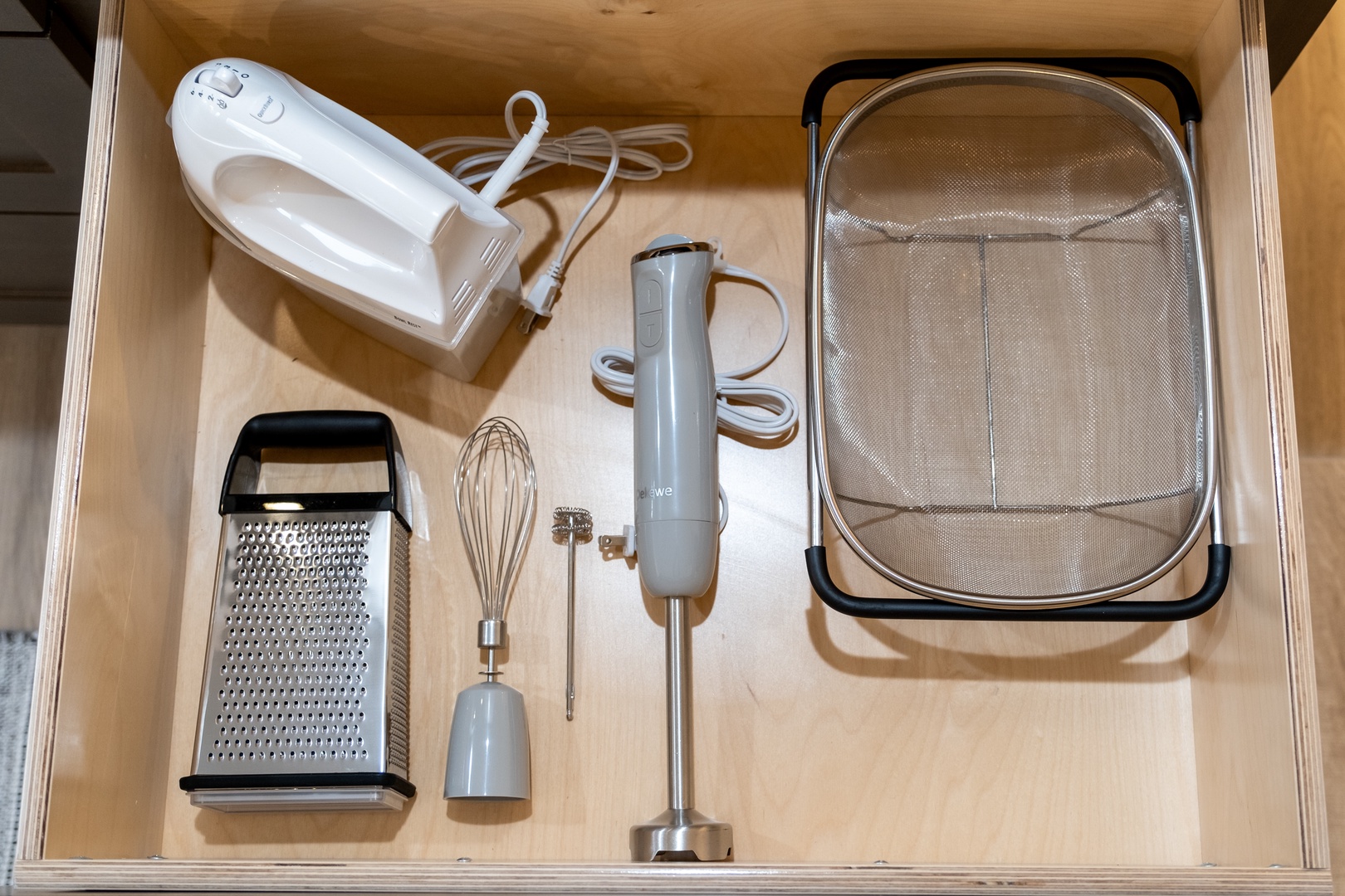Your kitchen drawer is stocked with everything you need to whip up delicious meals—from the hand mixer and immersion blender to the grater and strainer—making meal prep a breeze during your stay.