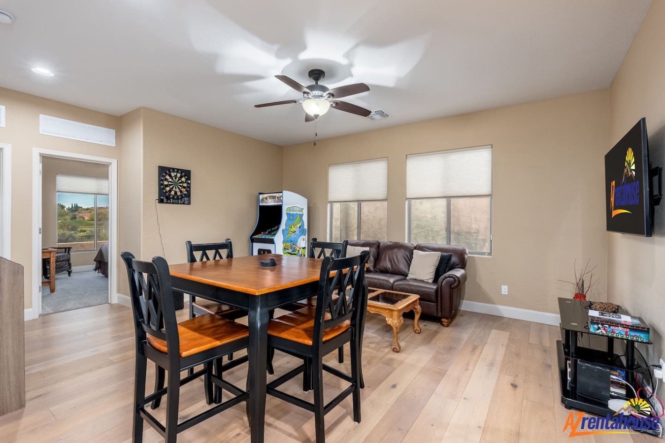 Unwind in your spacious game room featuring arcade fun, cozy leather seating, and dining space for memorable evenings together.