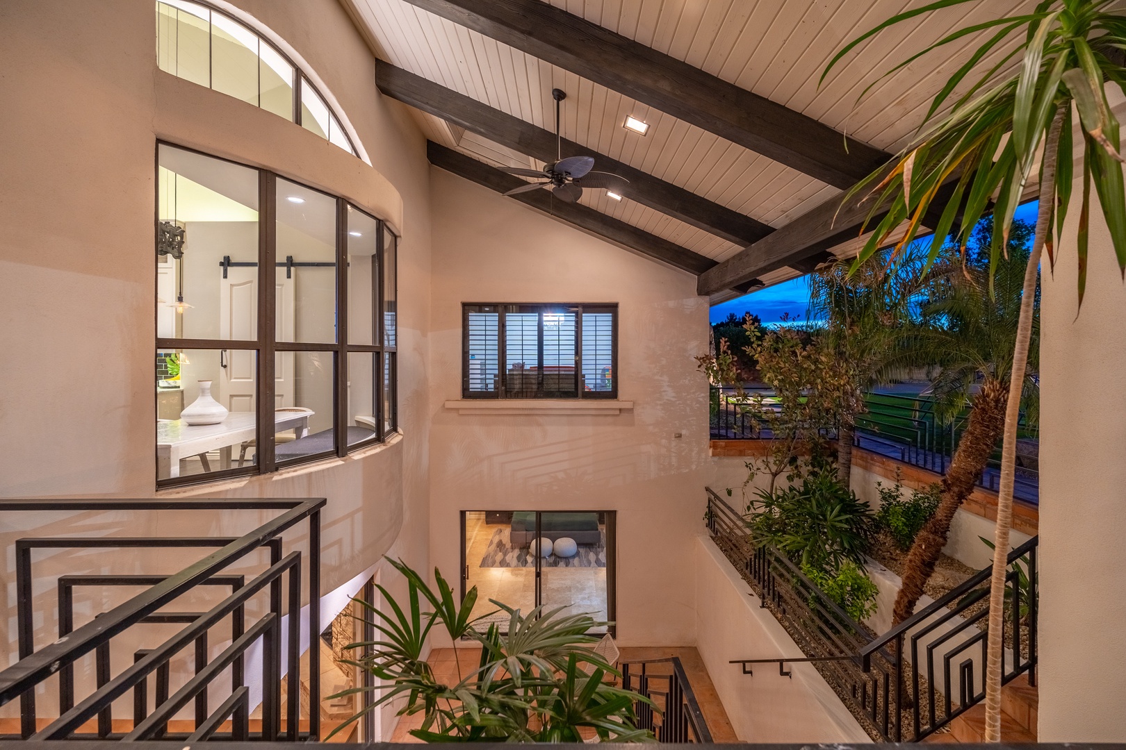 Warm wood beams and soaring ceilings create an airy, inviting atmosphere. Natural light flows in through large windows as lush plants bring the outdoors inside, making your stay feel peaceful and refreshing.
