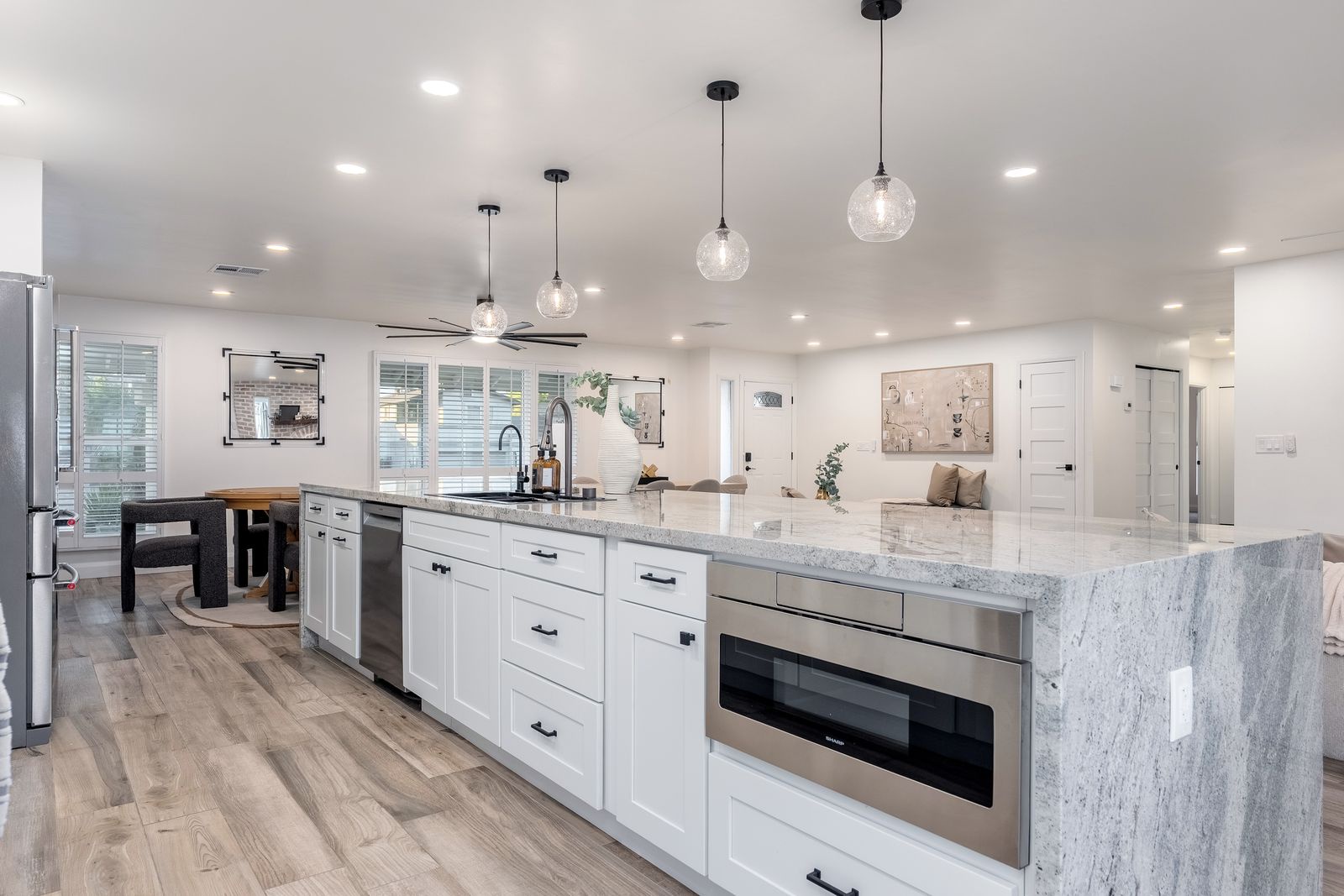 Picture yourself preparing meals in this chef-inspired kitchen with gleaming marble countertops, modern appliances, and elegant pendant lighting creating the perfect ambiance for your culinary adventures.