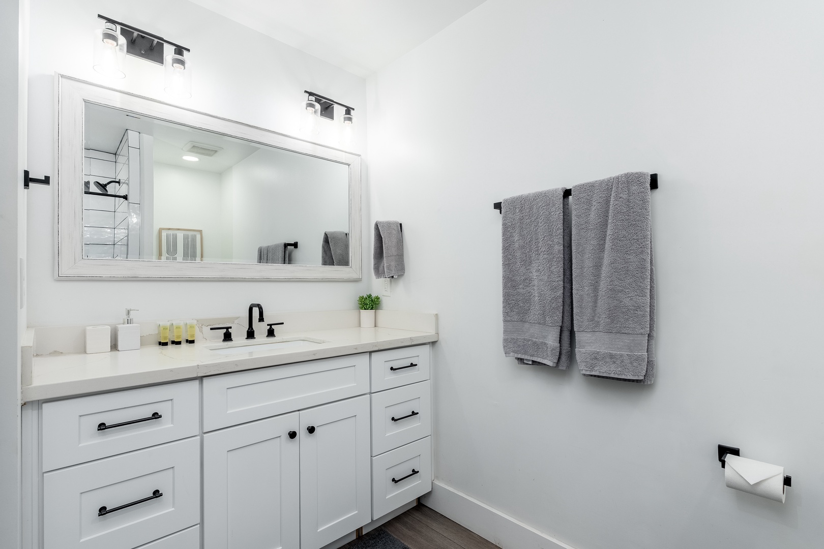 Step into a pristine white bathroom where modern elegance meets your comfort. Plush towels await and thoughtful amenities make this your personal retreat.