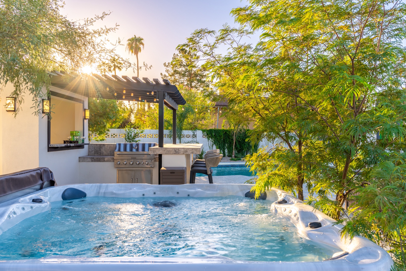 Soak in the bubbling hot tub surrounded by lush greenery, then fire up the grill for an outdoor feast under soft evening light—pure backyard bliss.
