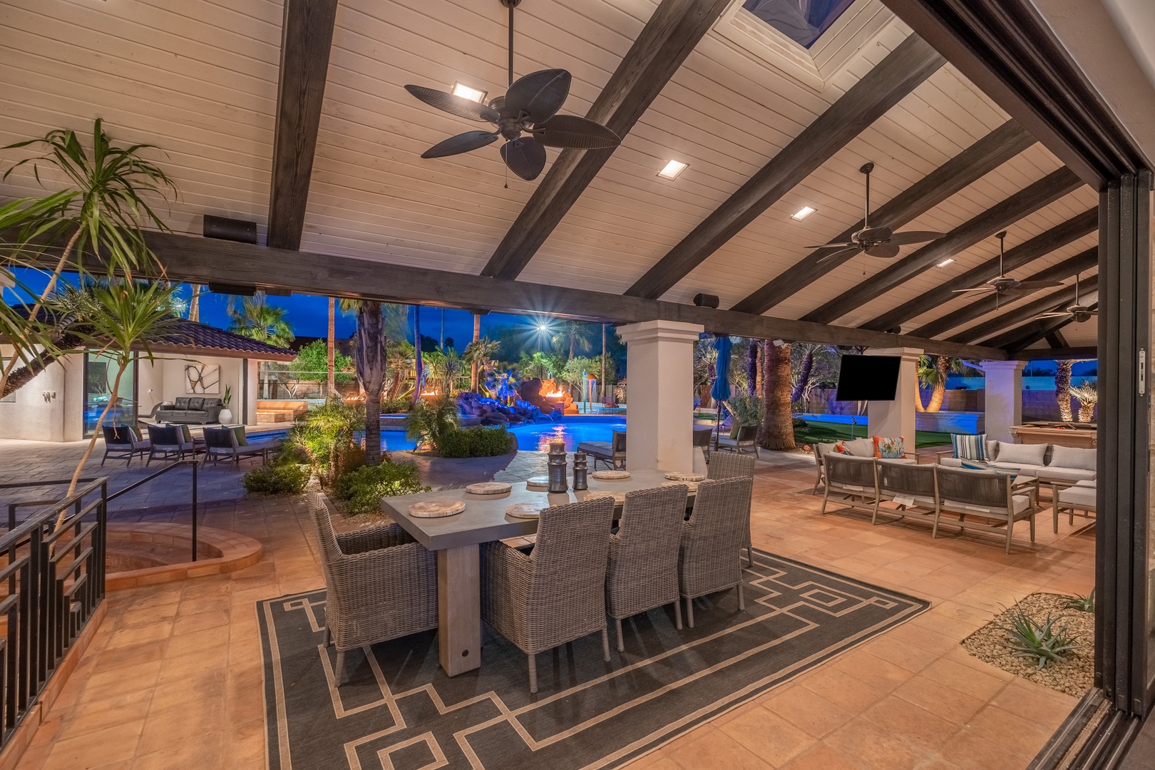 Enjoy alfresco dining under soaring beamed ceilings with ceiling fans cooling you as you relax. Views of the sparkling pool and tropical landscaping create a resort-like atmosphere for meals and gatherings.