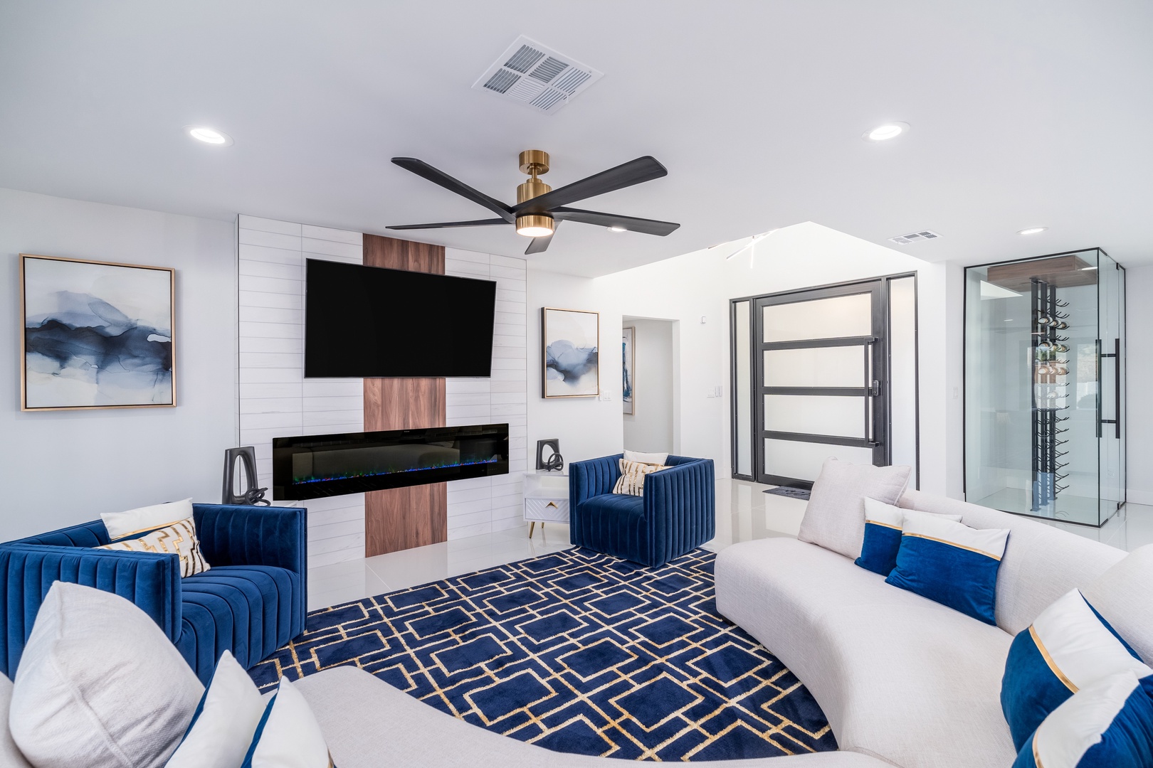 Sink into plush seating in this sophisticated living room where modern elegance meets comfort. Enjoy movie nights by the fireplace with a stylish geometric rug beneath your feet.
