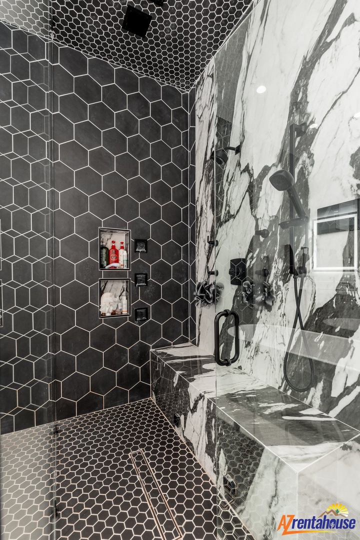 Step into your luxurious spa-like bathroom featuring striking hexagonal tiles and elegant marble accents for ultimate relaxation.