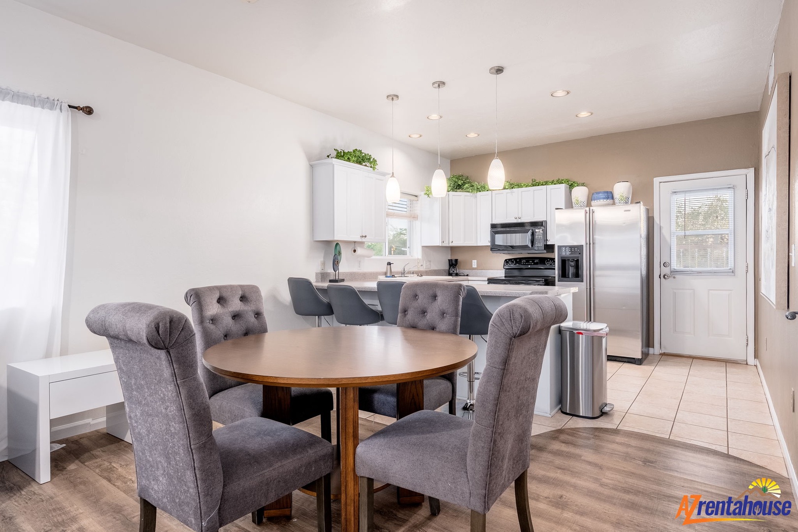 Gather around the spacious dining table where you can enjoy home-cooked meals in this bright, open-concept kitchen. The modern appliances and elegant seating make every meal feel special and effortless.