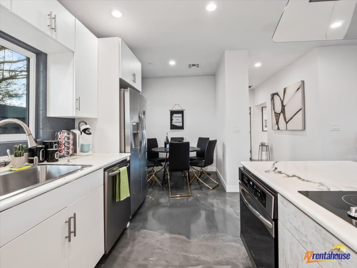 Your sleek kitchen flows into a stylish dining space, featuring modern appliances and polished concrete floors for memorable meals.