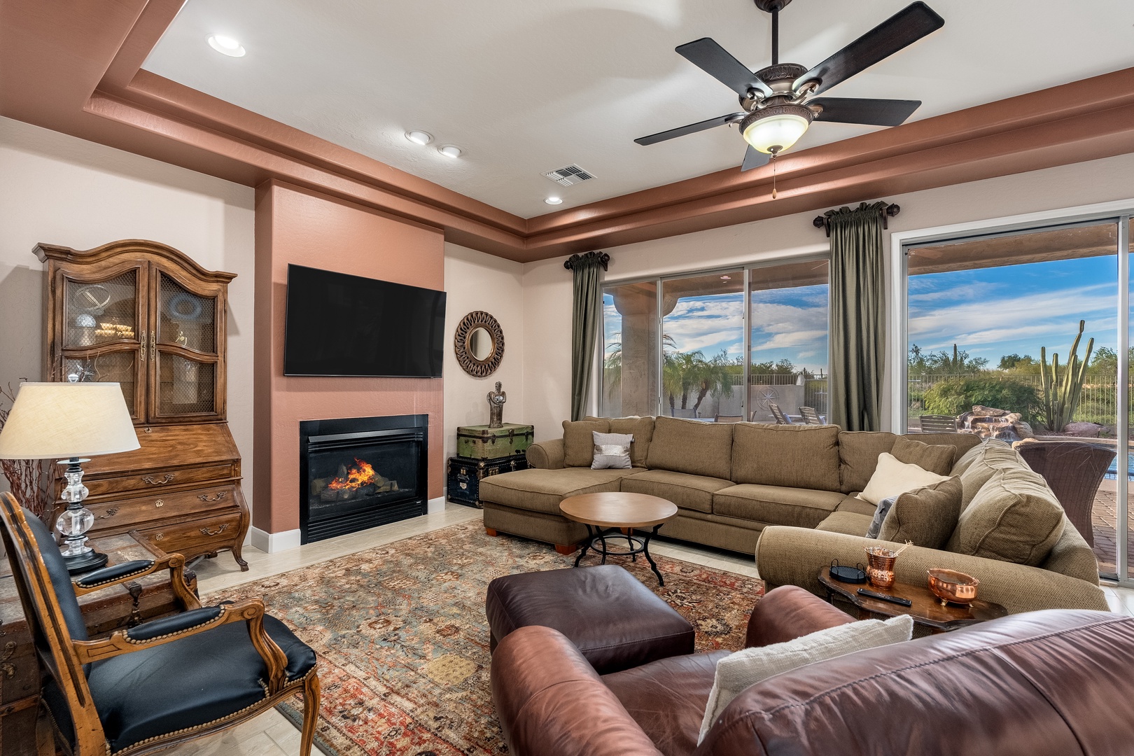 Unwind in your spacious living room where plush seating, a warm fireplace, and desert views create the perfect retreat for relaxation and conversation.