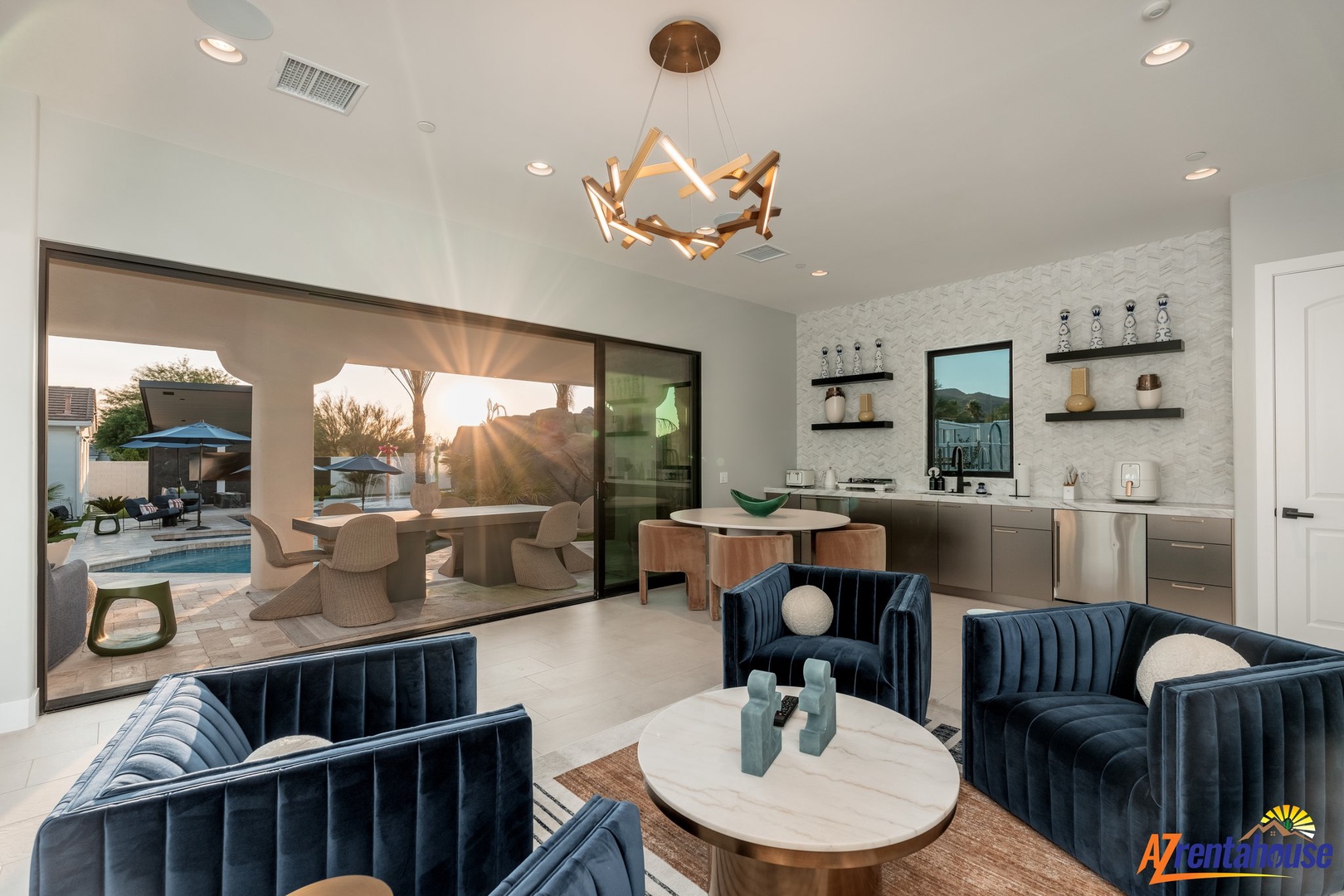 Settle into your stylish living room where modern elegance meets poolside luxury through floor-to-ceiling windows.