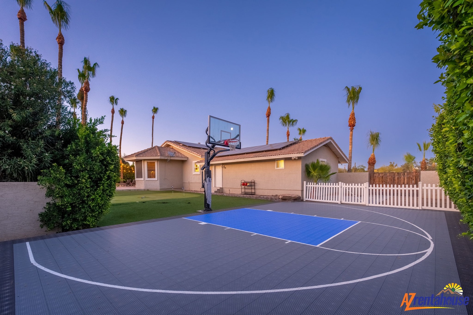 A private full-size basketball court set against palm trees and desert skies—ideal for active groups and family fun during your stay.