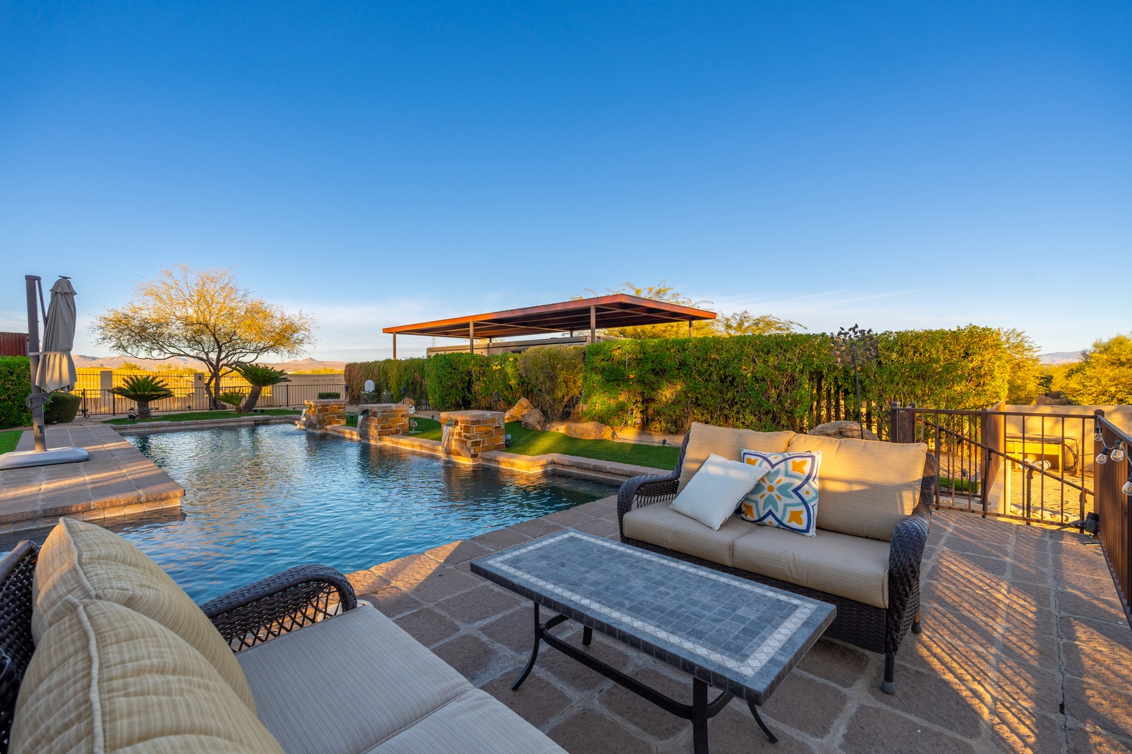 Bask in golden hour by your private pool oasis, where luxury outdoor living meets desert tranquility under endless Arizona skies.