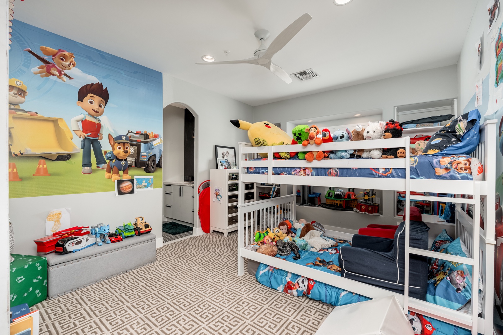A cheerful kids' room awaits your little ones, featuring fun character-themed decor and cozy bunk beds where they'll drift off to sleep after days of adventure.