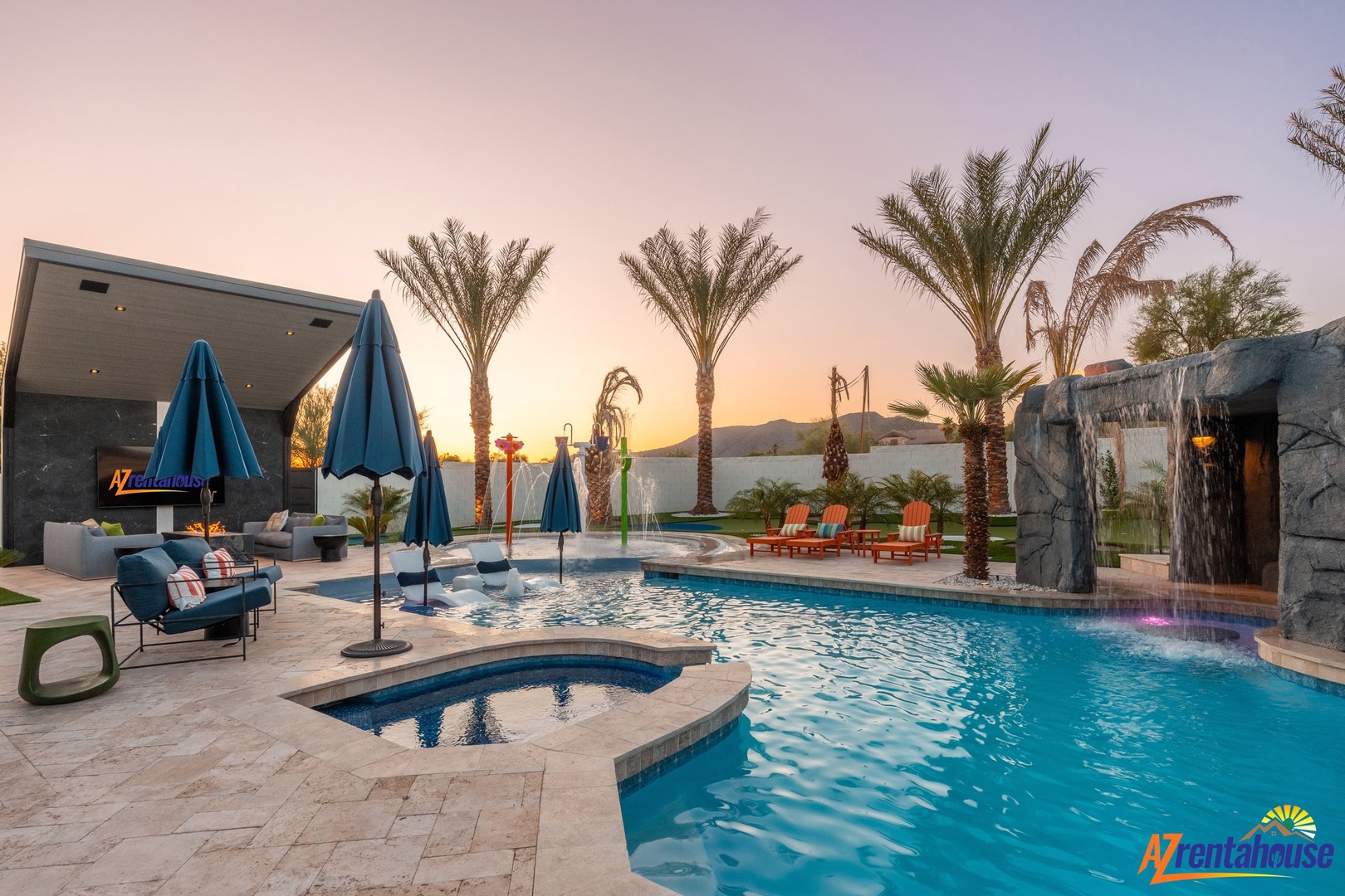 Stunning desert oasis with pool, hot tub, and mountain backdrop at sunset.