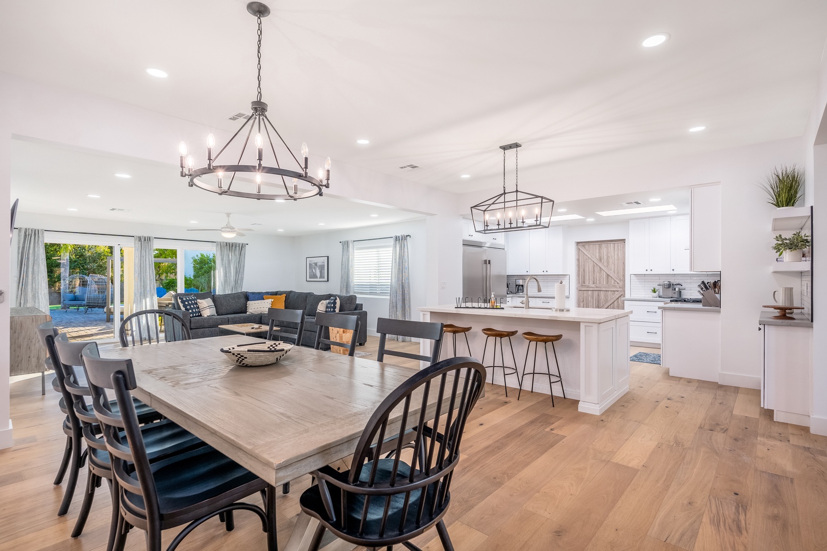 Gather with loved ones in this airy, sunlit space where the dining area, living room, and chef's kitchen flow seamlessly together—perfect for laughter, meals, and making memories.