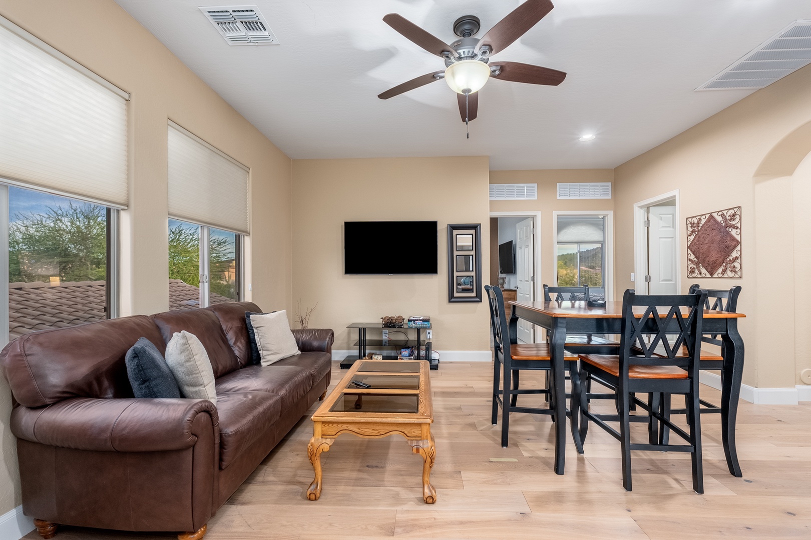 Your open-concept living and dining space invites comfort and connection, with plush seating, a smart TV, and a dining table perfect for gathering over meals or games.