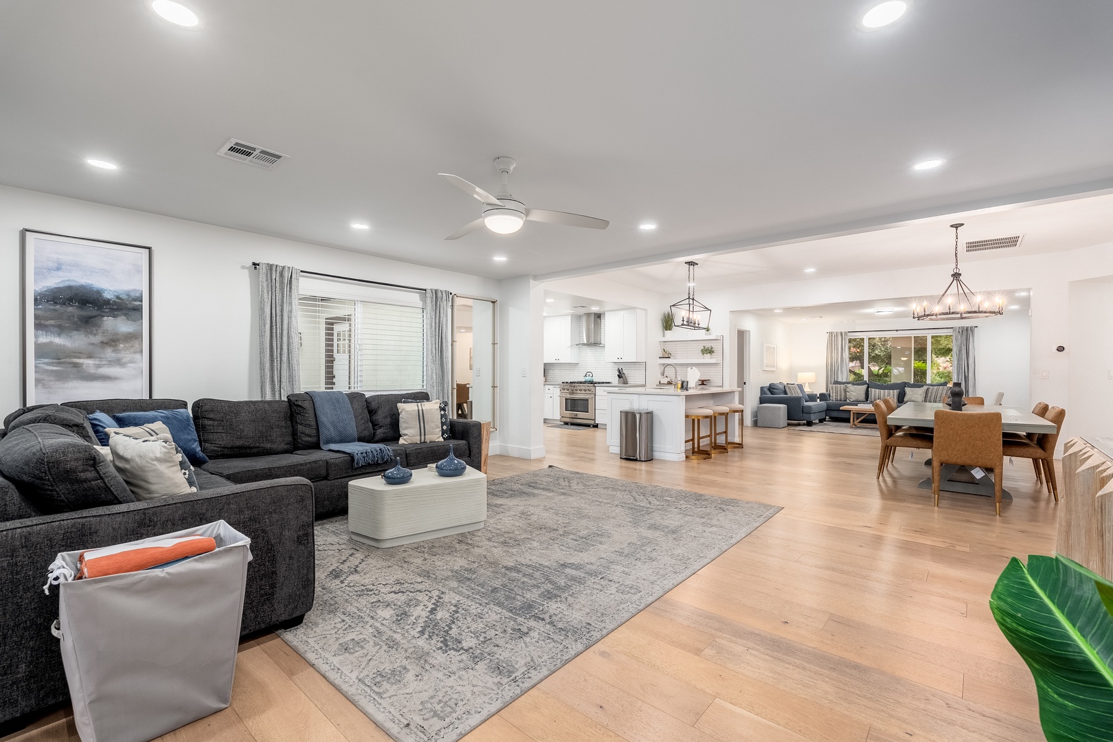 Sink into plush seating in your open-concept living space, where natural light flows through expansive windows and modern finishes create an inviting atmosphere for relaxation and connection.