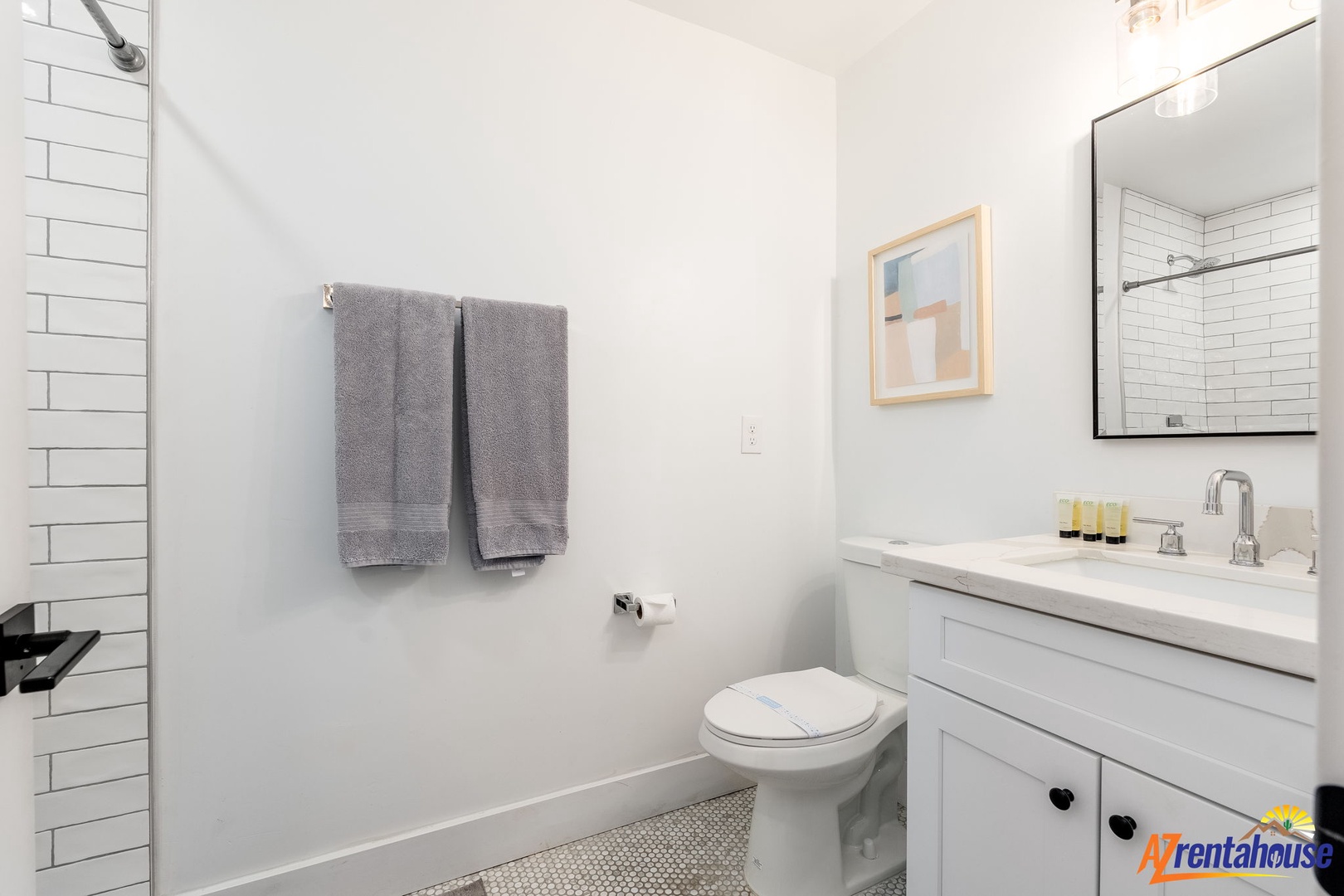 Step into your pristine bathroom with subway tile shower, marble countertops, and thoughtful touches that make your stay feel luxurious.