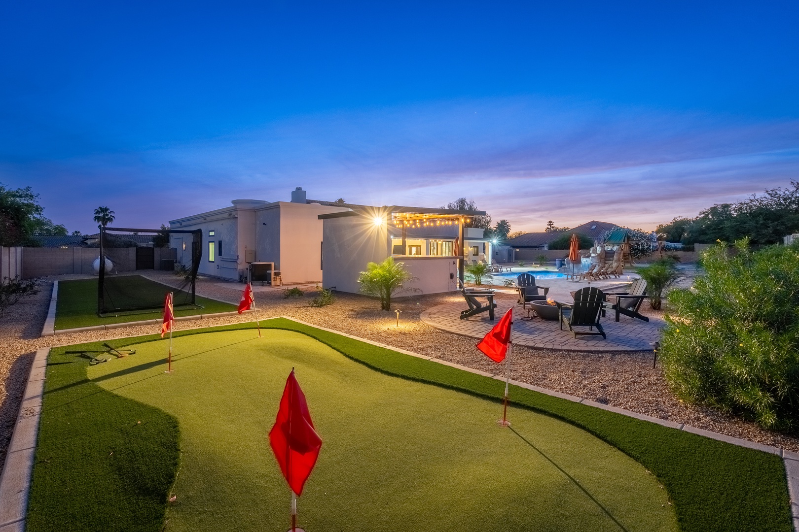 This property features a private putting green, sparkling pool, and expansive outdoor spaces ideal for sunset gatherings and evening relaxation.
