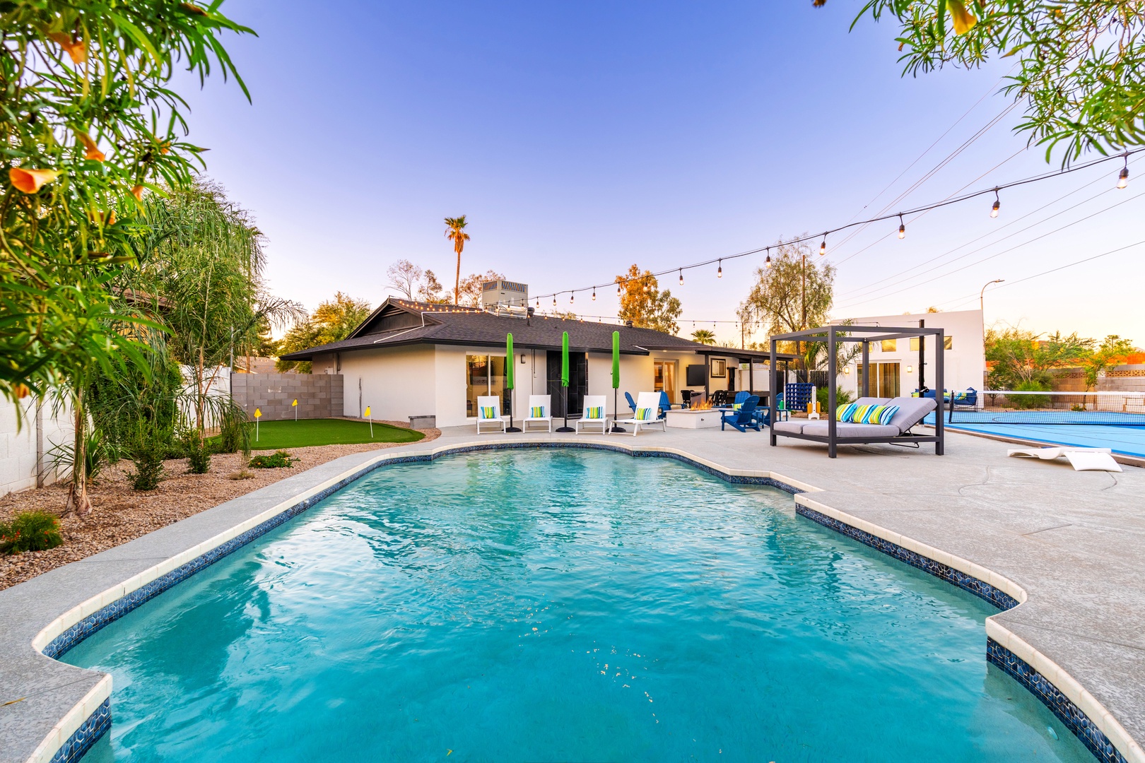 Picture yourself lounging by your own private pools, surrounded by lush greenery and stylish outdoor seating—perfect for soaking up the sun or enjoying evenings under string lights.