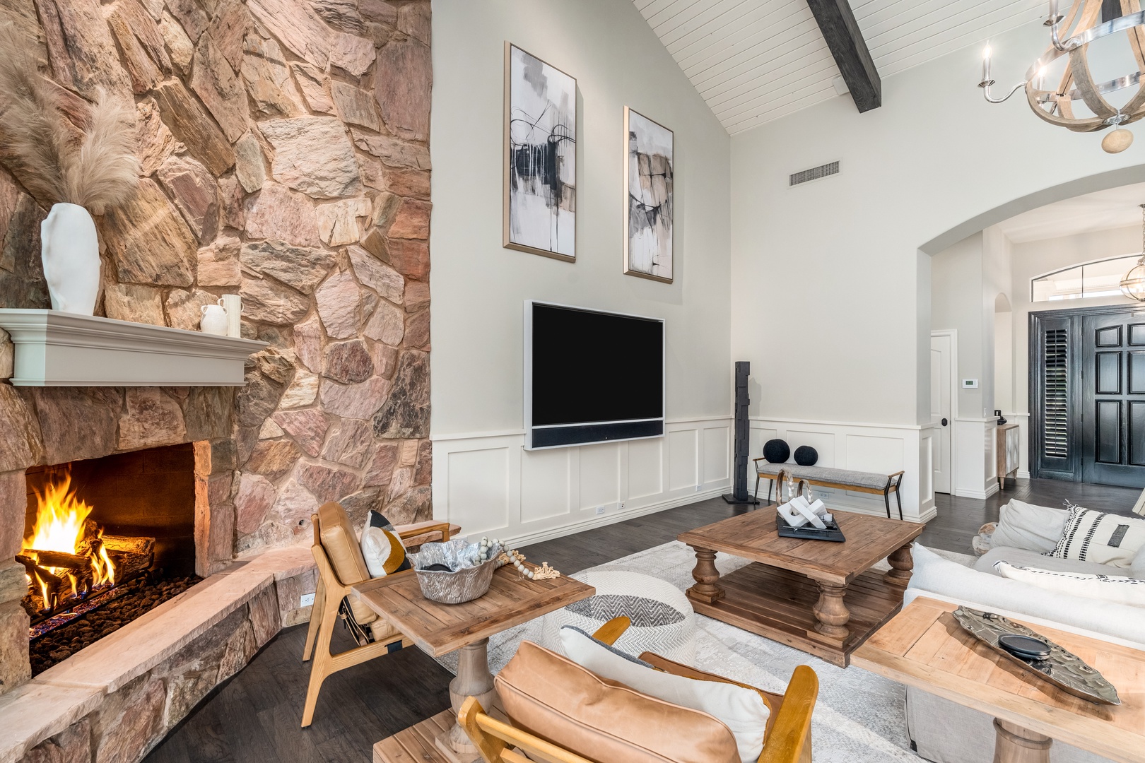 Gather around the glowing stone fireplace while vaulted ceilings and rustic wood beams create your cozy retreat for unforgettable mountain evenings together.