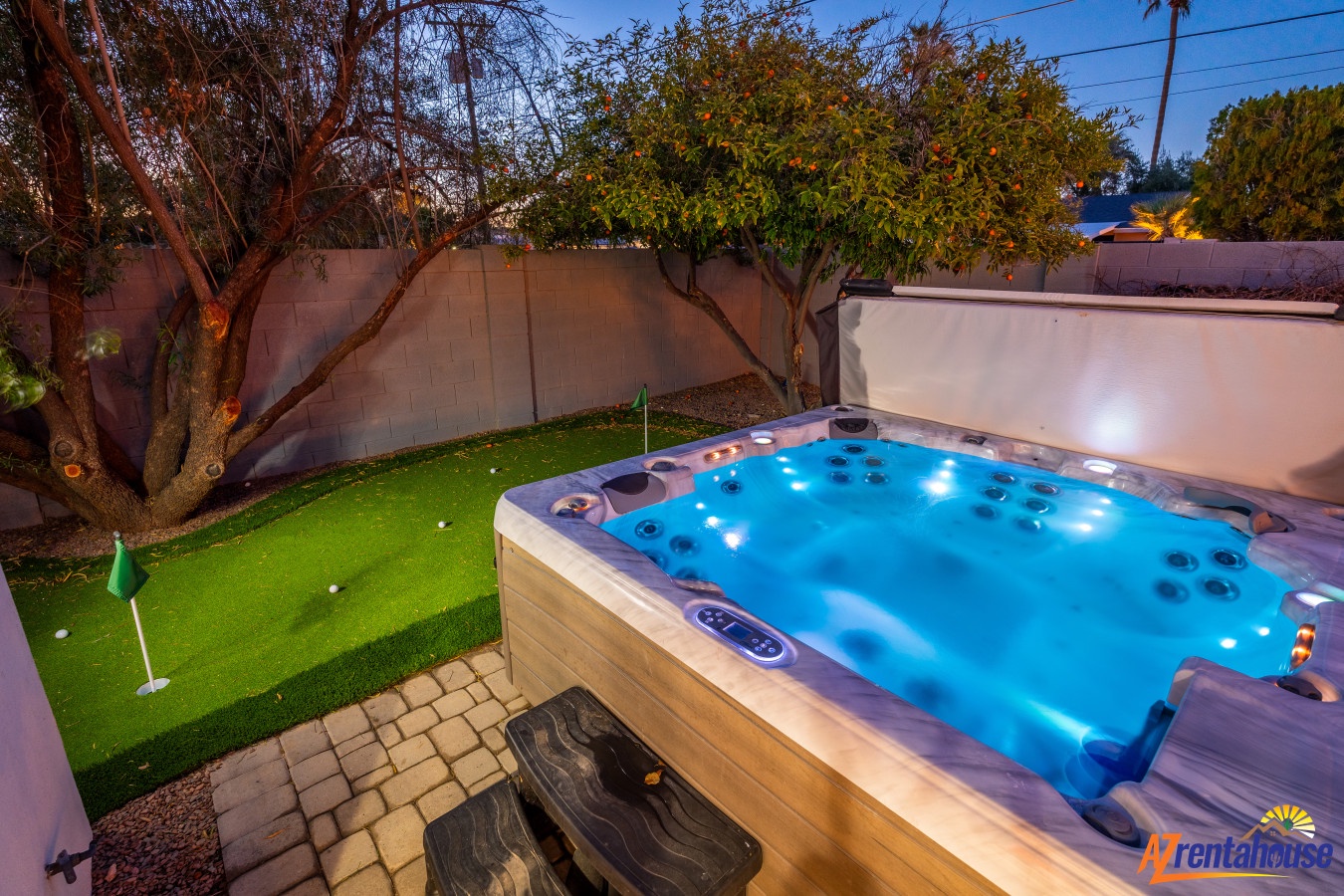 Unwind in your private hot tub under the stars, then practice your putting on the mini golf green in this enchanting backyard oasis.