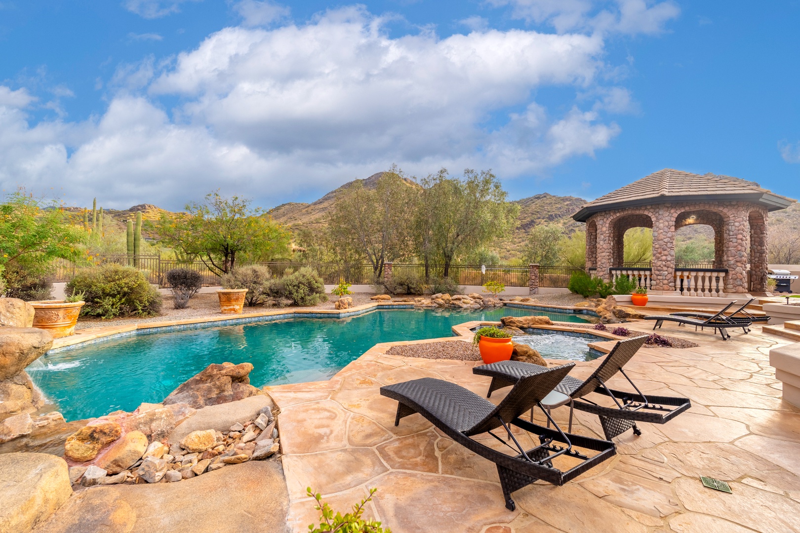 Turquoise waters beckon beneath desert skies, framed by mountain views. Lounge poolside or retreat to the shaded gazebo—your own private desert oasis awaits.