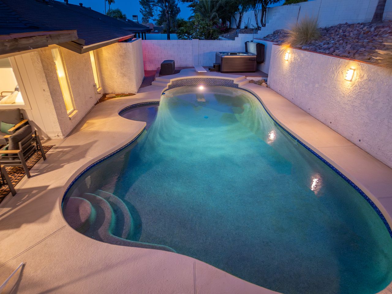 Slip into your private pool after a long day, with ambient lighting and a hot tub waiting just steps away for the ultimate evening retreat.