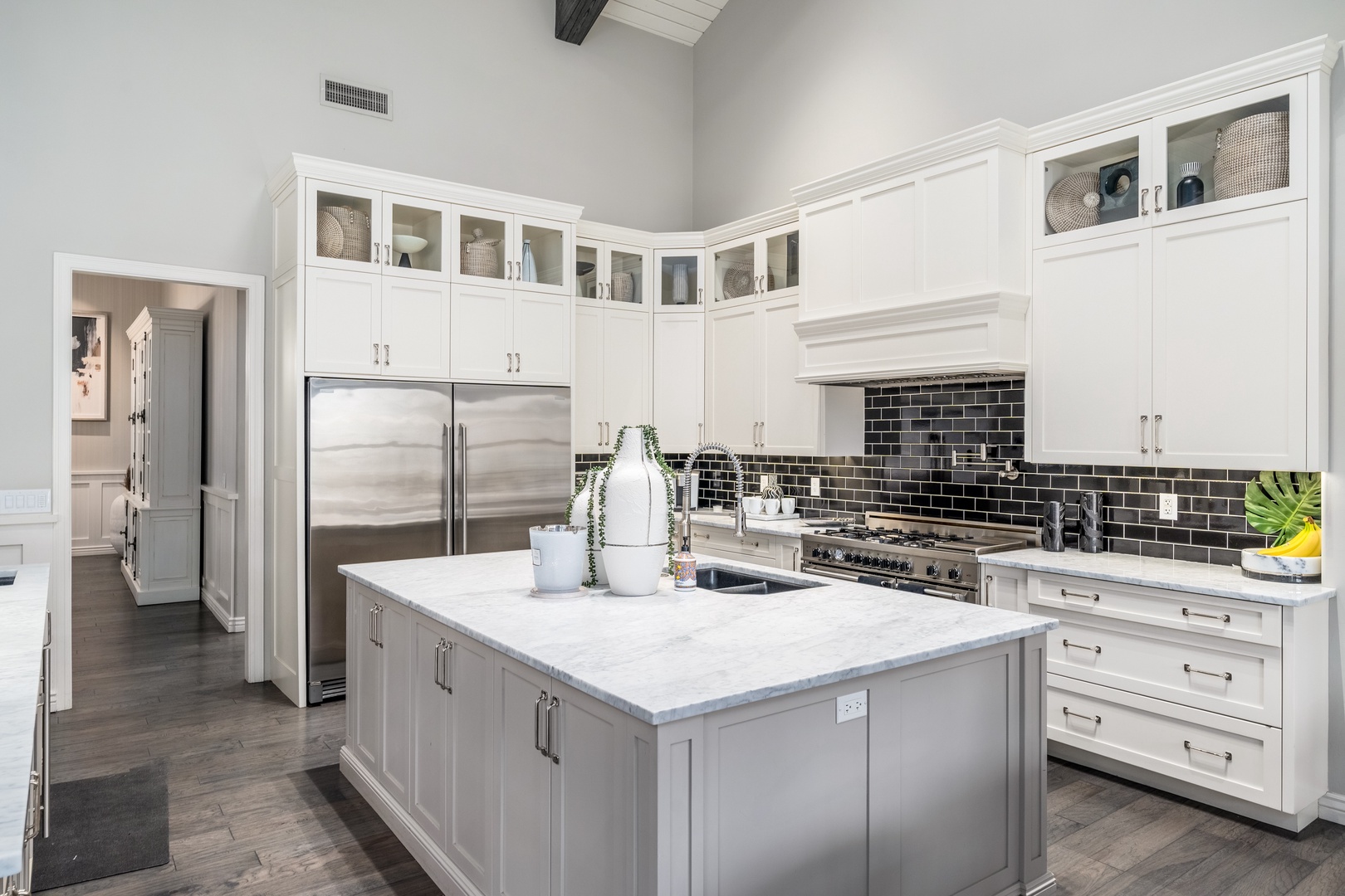 Your chef's kitchen awaits with gleaming marble counters, a spacious island, and stainless steel appliances—ready for morning coffee or gourmet meals.