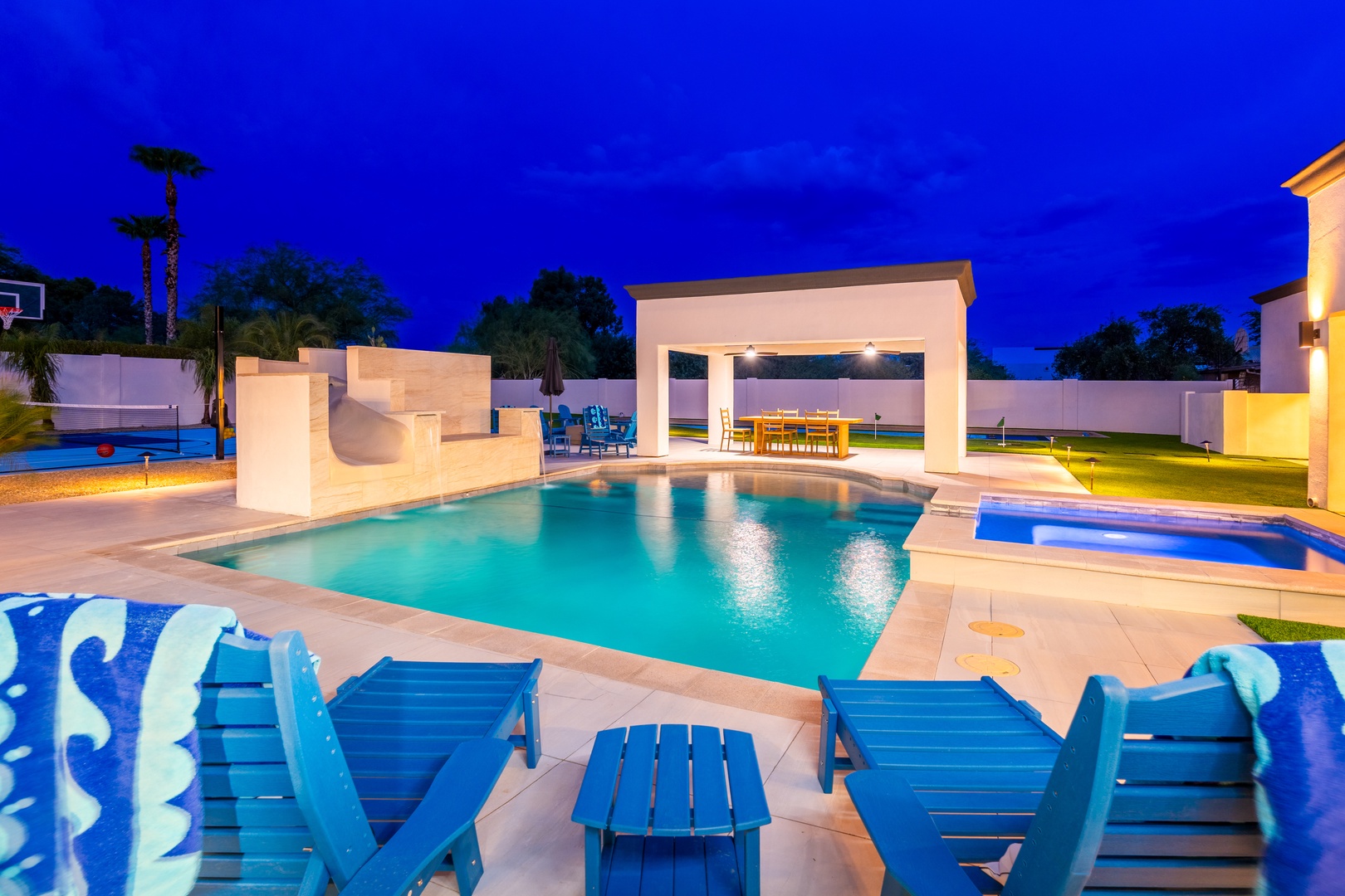 Modern pool oasis at twilight, featuring your private pool with lounge seating, covered pavilion, and spacious backyard designed for relaxation and entertaining under the stars.