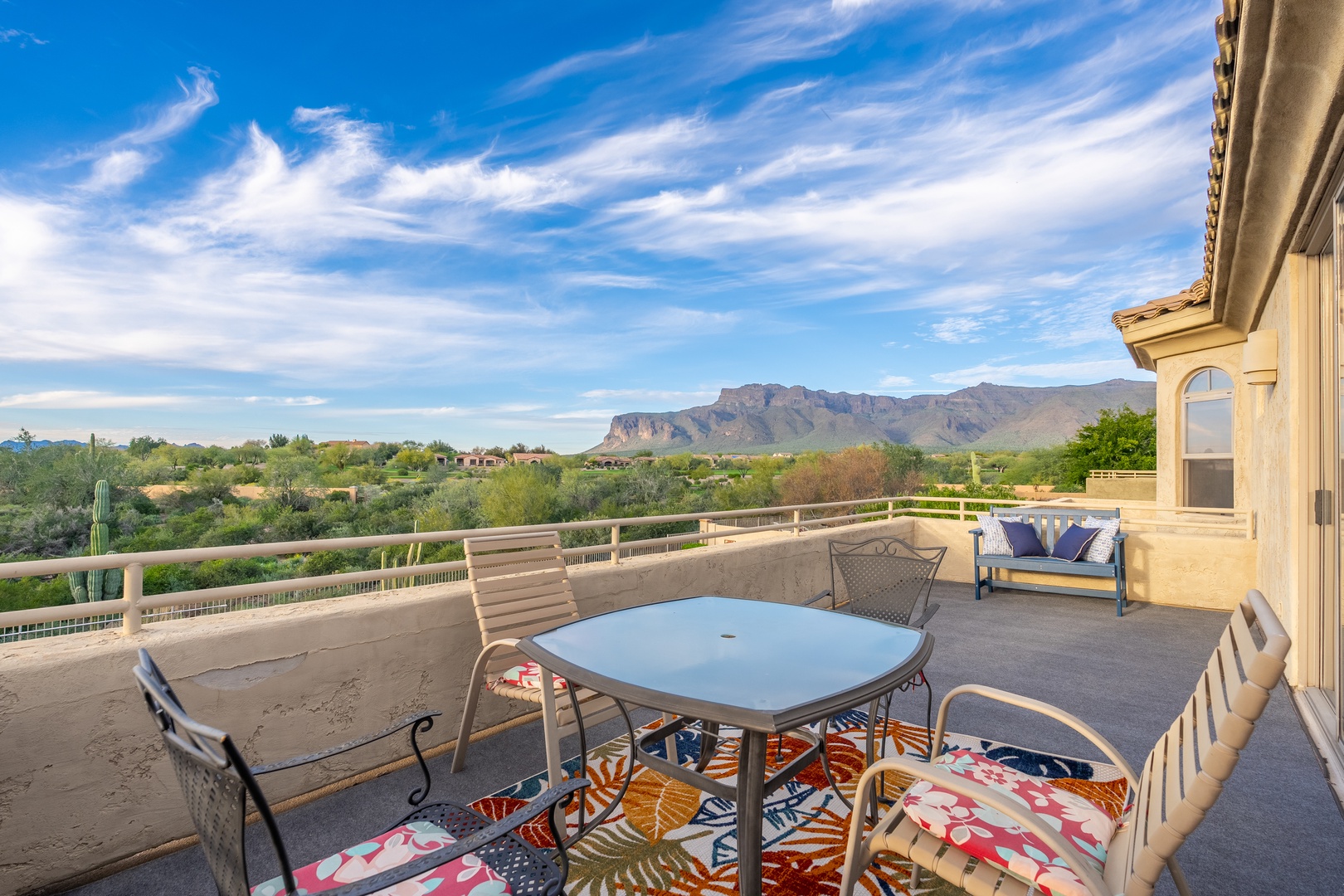 Spacious balcony with comfortable seating overlooking dramatic mountain vistas and expansive desert landscape—your perfect spot for morning coffee or sunset relaxation.