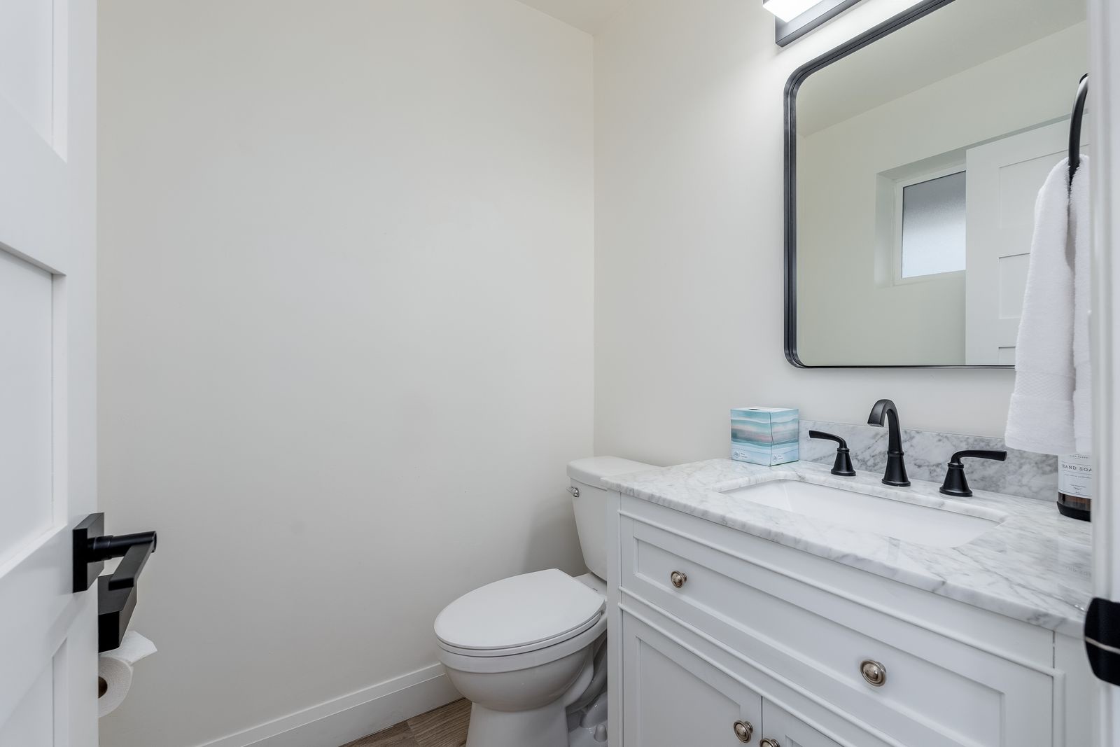 Your private bathroom features a crisp white vanity with marble countertop, modern fixtures, and fresh towels awaiting your arrival.