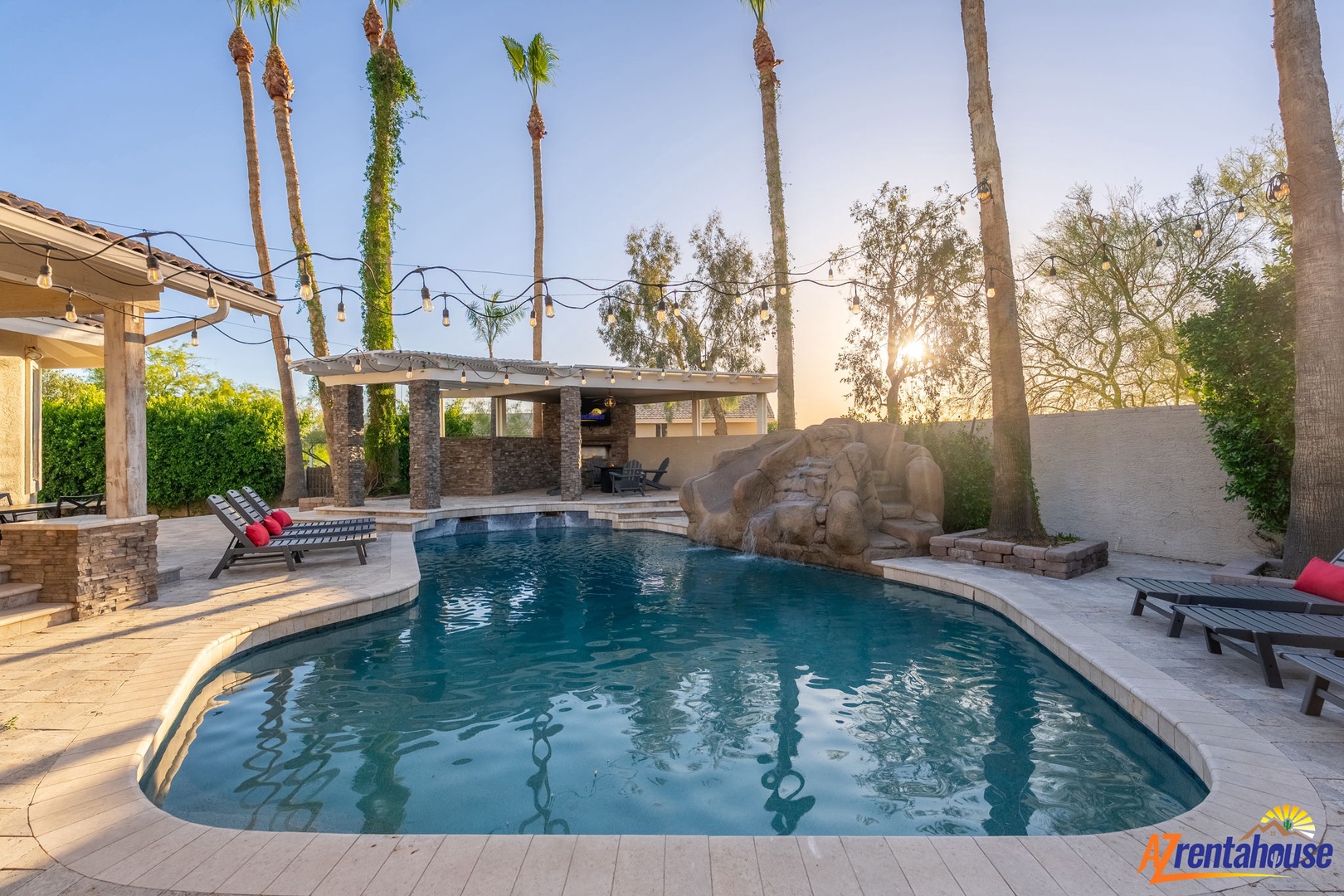 The sparkling pool invites relaxation under swaying palms. Lounge poolside as sunlight filters through mature landscaping, or unwind in the outdoor seating areas perfect for memorable evenings together.