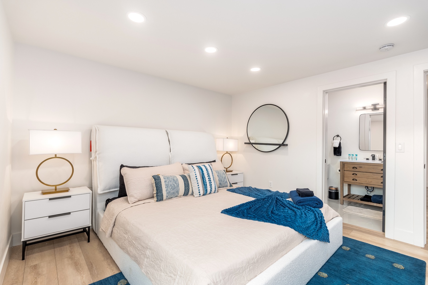 Slip into your serene bedroom retreat, where coastal-inspired accents and soft lighting create the perfect atmosphere for peaceful nights and refreshing mornings in your home away from home.